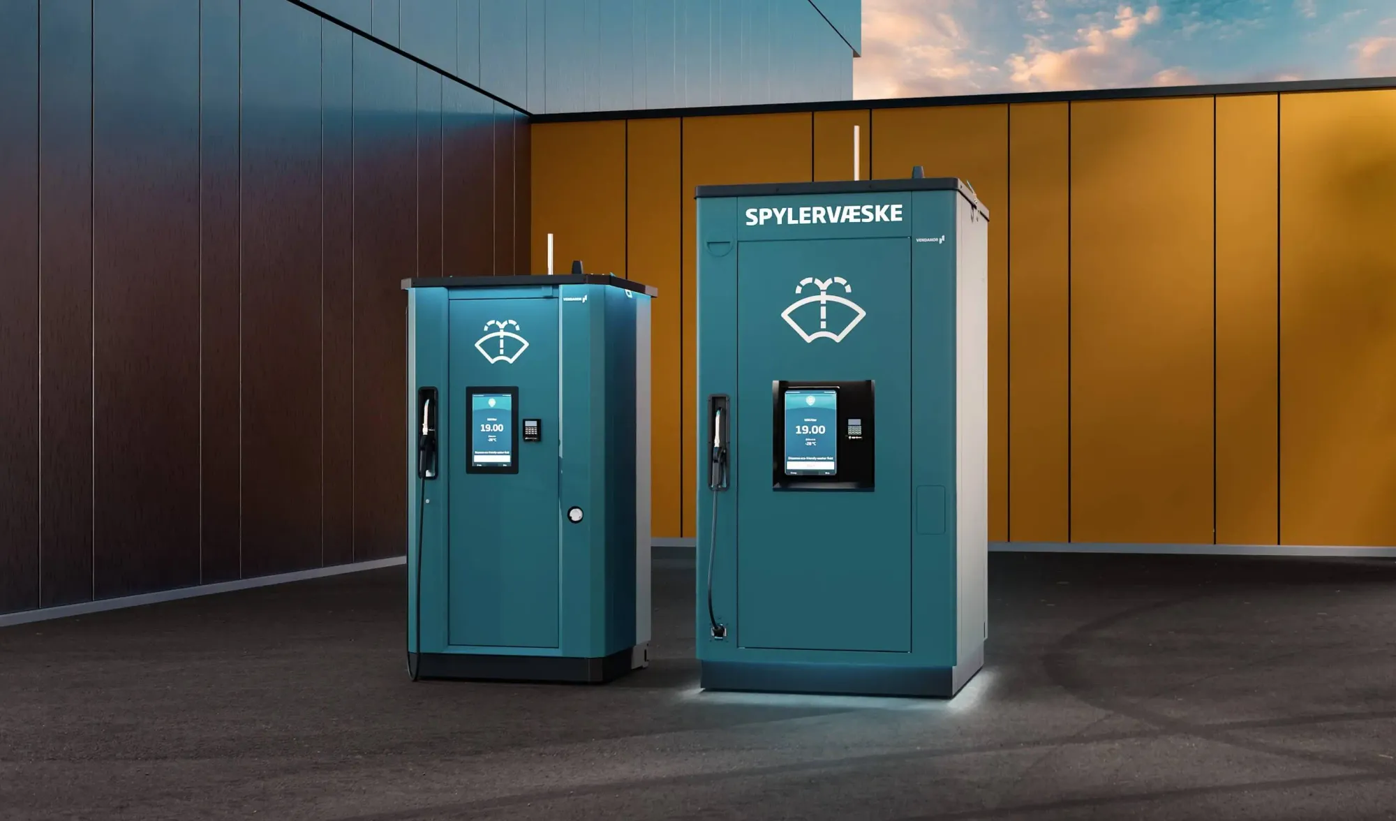 Vendanor Washer Fluid Dispensers Compact 650 and Standard 1500 in front of an orange-clad building at dusk.